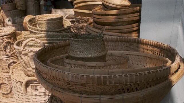 Handmade woven baskets, trays and traditional wicker products displayed for sale in Chiang Mai, Thailand. Sustainable products, natural materials, eco-friendly lifestyle, traditional craftsmanship