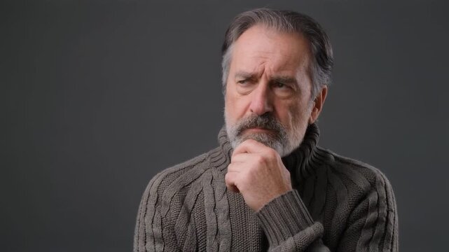 Elderly Man's Pensive Thoughtful Gesture in Soft Studio Lighting with Copy Space
