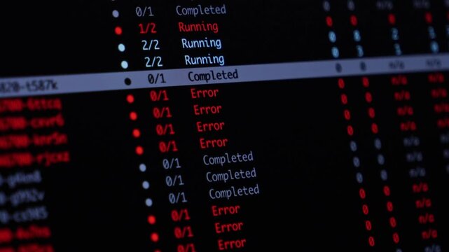 Programming code monitoring software status displays running, completed, and error alerts on a dark computer monitor screen to indicate a complex system failure or debugging. Zoom