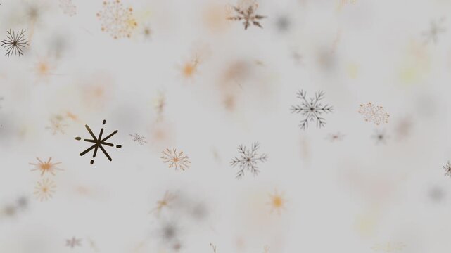 Golden and grey snowflakes falling slowly on a light grey background