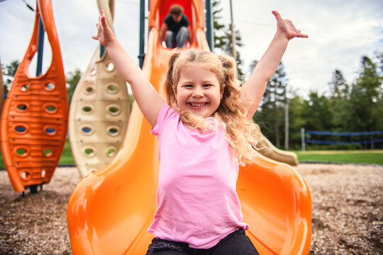 Little girl on a slide outdoors in a park