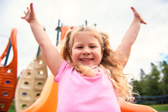 Little girl on a slide outdoors in a park