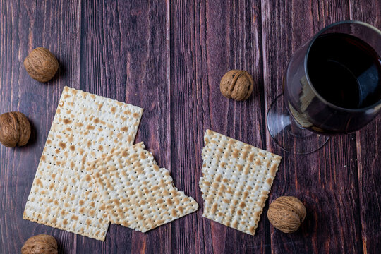 Traditional matzo and whole walnuts on rustic wooden table