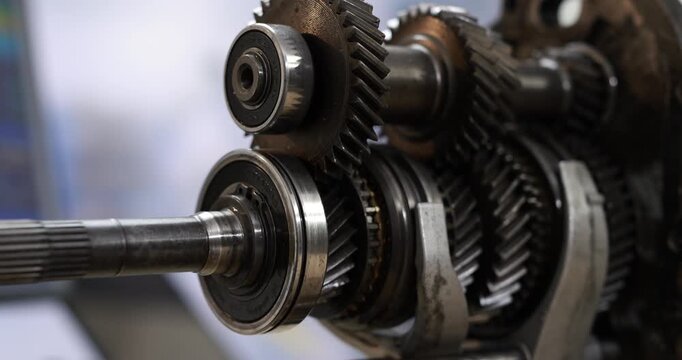 Close-up of steel gears, shafts and bearings inside a manual transmission, precision automotive engineering and mechanical parts.