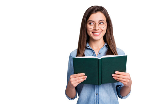 Photo of optimistic sweet long brunette hairdo lady look empty space hold copybook wear spectacles blue cloth isolated on grey background