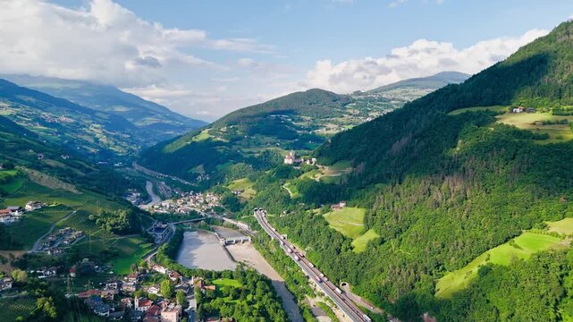 Trucks and cars cross a motorway viaduct in South Tyrol, Italy. Drone footage of road transport through the Italian Alps