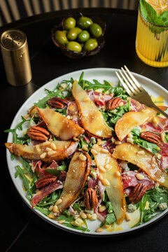 Salad with Pear, Arugula, Jamon, Blue Cheese and Blueberry, Delicious Fresh Salad Appetizer on Bright Background