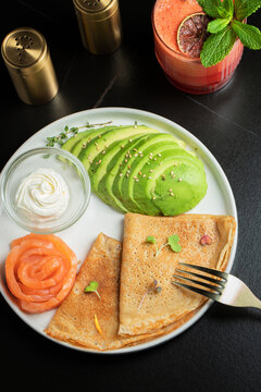 Roasted thin pancakes with smoked salmon and sauce