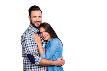 Fototapeta premium Portrait of beautiful, cheerful, positive, nice couple in shirt enjoying hug with each other, looking at camera over grey background