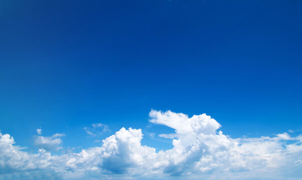 blue sky background with tiny clouds