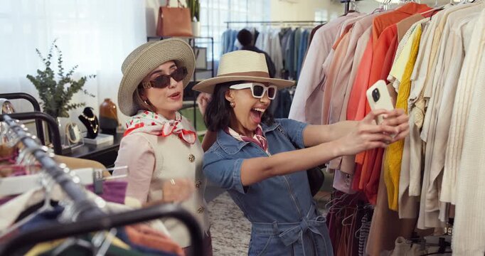 Fashion, funny face and selfie with friends in shopping mall for consumerism or retail purchase. Hat, picture and sunglasses with happy women in clothing boutique for bargain, sale or social media