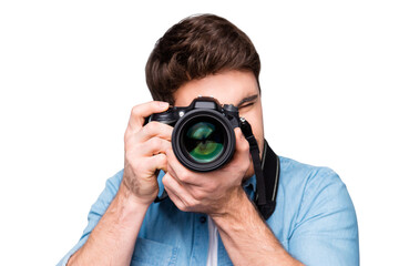 Portrait of guy in jeans shirt looking at photo camera, shooting photographs during excursion, making photosession over gray background © deagreez