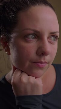 Caucasian woman sitting by sunlit residential windowpane expressing tranquil philosophical rumination mental clarity serene balance and mindful life assessment