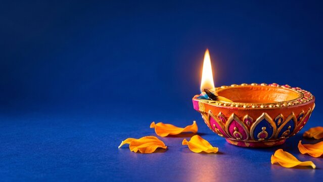 Diya lamp on blue background