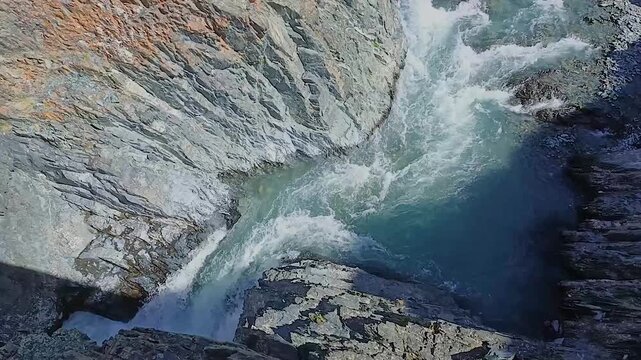 a mountain river flows into a gorge