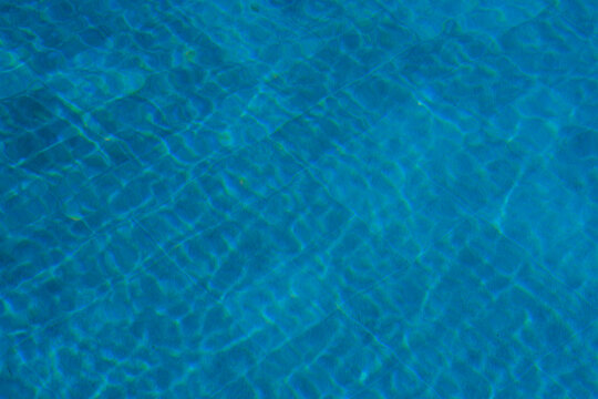 Water ripples on a blue pool background