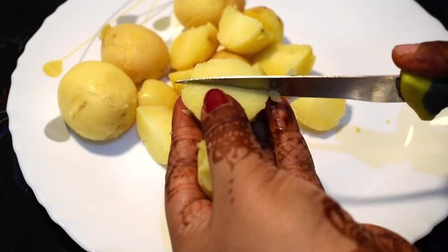 making navratri vrat special potato dish with boiled potato cutting