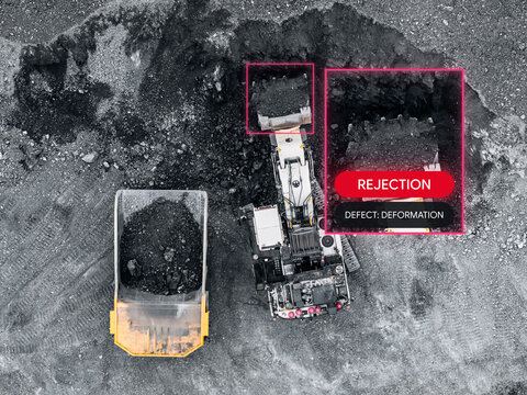 AI based computer vision for analyzing integrity of machinery truck and bucket teeth of excavator during open pit ore mining, drone top view.