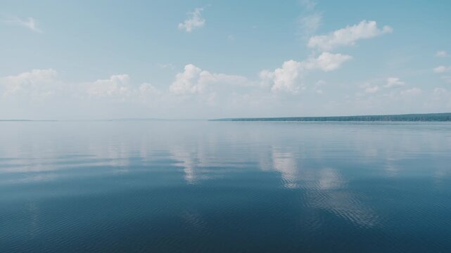 Calm lake surface during sunny summer day