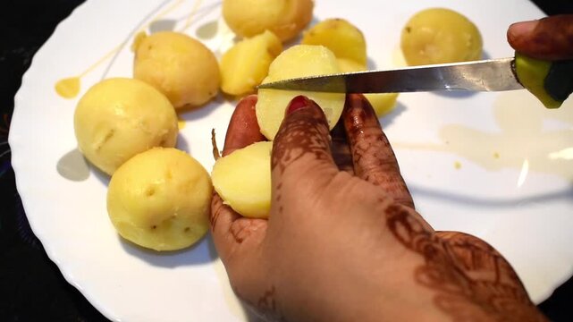 cutting boiled potato with knife
