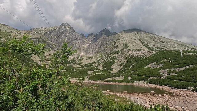 lomnicky stit peak upper station cable car cabin ascent high tatras carpathians mountain landscape green valley hiking trail slovakia scenic alpine nature summer clouds concept of travel tourism