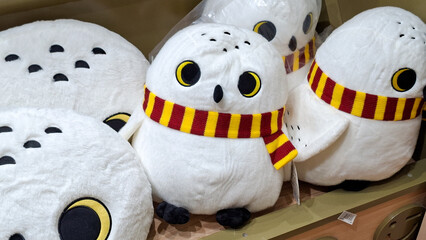 Obraz premium cute white harry potter hedwig snowy owl plush dolls and cushions wearing gryffindor scarf on September 16, 2026 in Bangkok, Thailand.