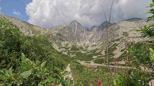 lomnicky stit peak view high tatras carpathians mountain landscape green valley cable car slovakia scenic alpine nature summer clouds concept of travel tourism outdoor adventure