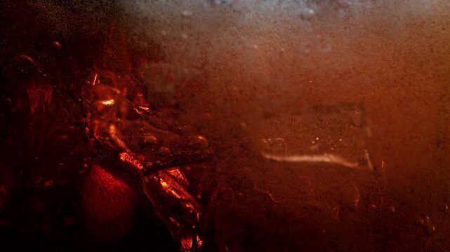 Super Slow Motion Shot of Ice Falling into Fresh Cola Lemonade at 1000fps.