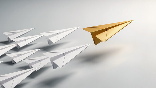 Gold paper plane leading a group of white paper planes on a light grey background, leadership and standing out concept with wide copy space for text