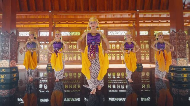 Traditional Javanese Dancers Performing Synchronized Movement in Pendopo