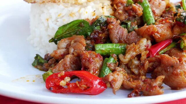 Thai Stir-Fried meet with Red Curry Paste Served Over Rice with Fried Egg