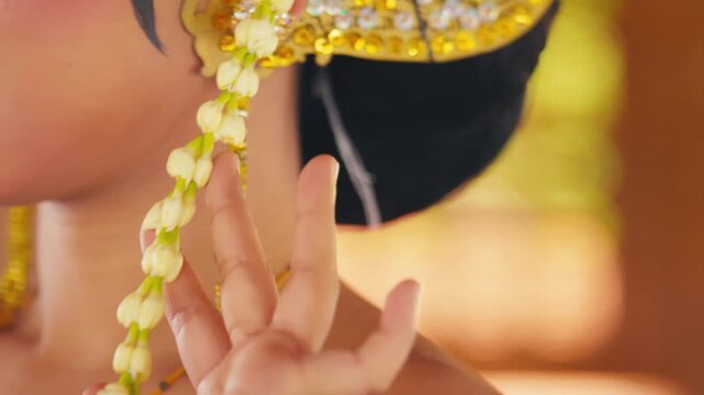Macro Shot of Hand Adjusting Golden Ear Cuff on Dancer