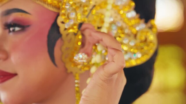 Close Up of Dancer's Hand with Golden Bracelet Touching Necklace