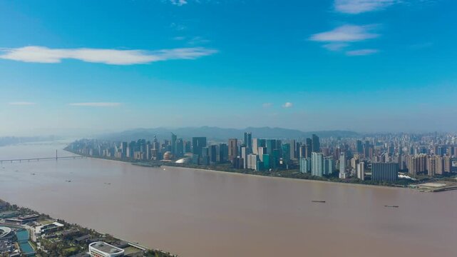 Aerial View of Hangzhou City Skyline Along Qiantang River with Bridge and Mountains in Hangzhou, China