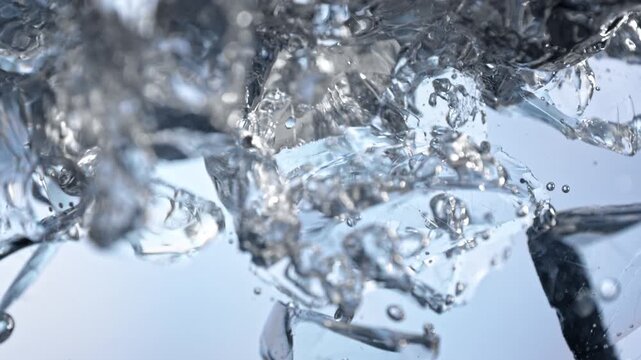 Super Slow Motion Shot of Clear Ice Cubes Falling into Water at 1000fps.