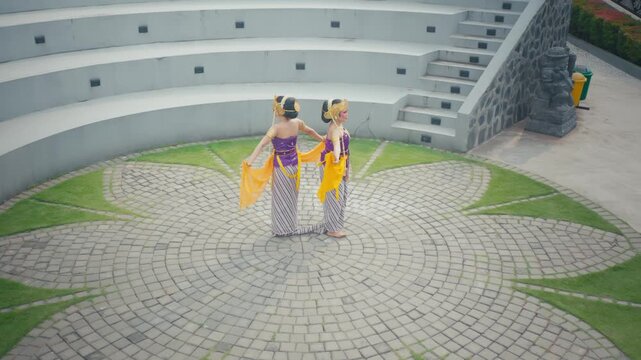 Top Down View of Dancers Displaying Colorful Costumes in Garden