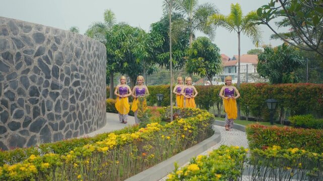 Side View of Cultural Dance Troupe Walking Through Green Park