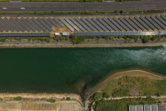 Aerial drone photo of solar panels along a river in Awaji City, Hyogo, Japan
