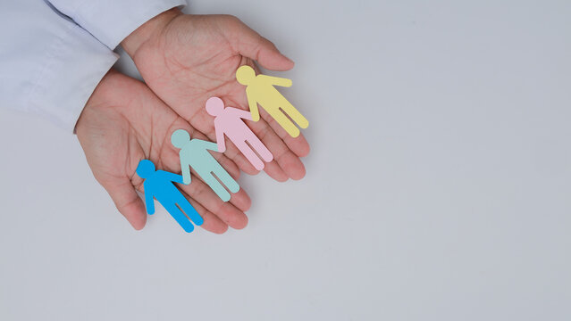 Doctor hand holding paper family cut with hopeful care and protect gesture on white background, showing love, unity, and support