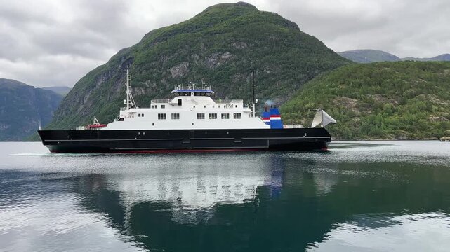 Car ferry with open visor on fjord during the turning