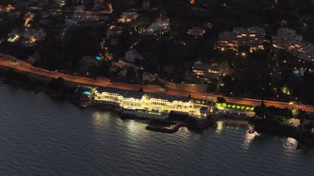 Aerial view of illuminated coastal building in Antibes, France.