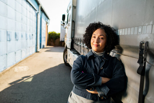 Confident woman truck driver at warehouse depot