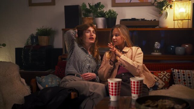 Young female friends having an emotional conversation and support at home