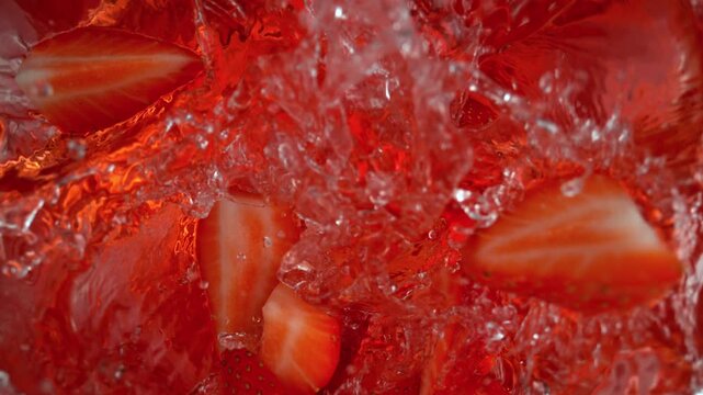 Super Slow Motion Shot of Fresh Strawberries Falling into Water at 1000fps.