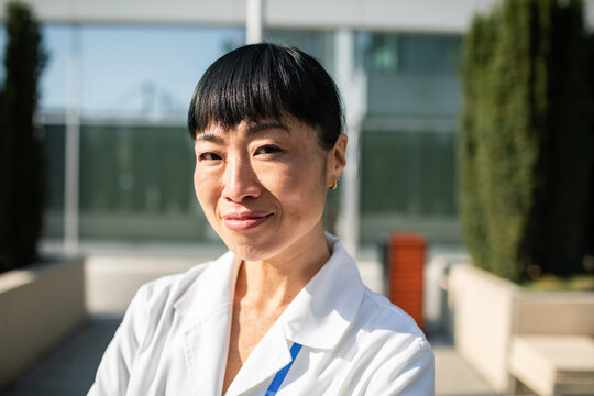 Confident female doctor portrait outdoors at hospital