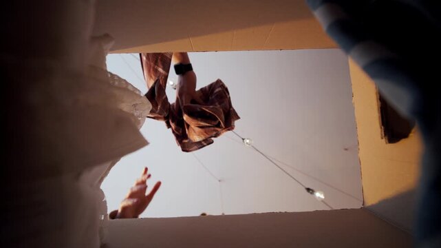 People looking into a cardboard box