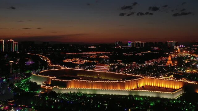 Illuminated Ancient City Wall and Skyline at Night in Xian, China