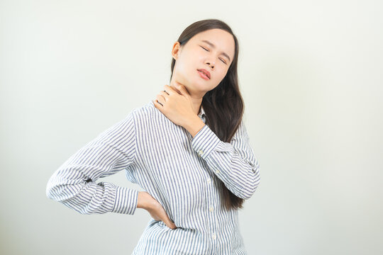 Pain body muscles stiff problem, asian young woman, girl painful with back, neck ache from work hand holding massaging rubbing shoulder hurt, sore on white background. Health care and medicine concept