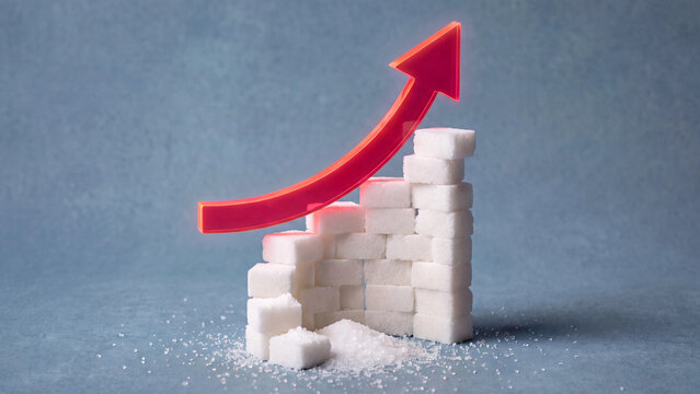 Sugar cubes stacked as rising bar chart with red arrow showing increasing sugar consumption and health risk concept