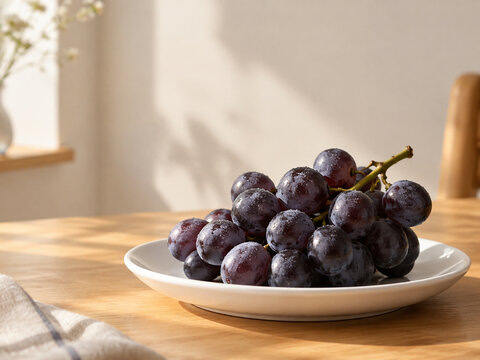 Dark purple grapes on white dish, healthy snack and fresh produce concept